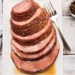 boneless brown sugar ham platted on a rectangular platter