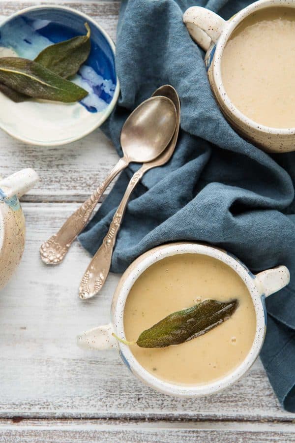 bowl of soup and vintage spoons on blue napkin