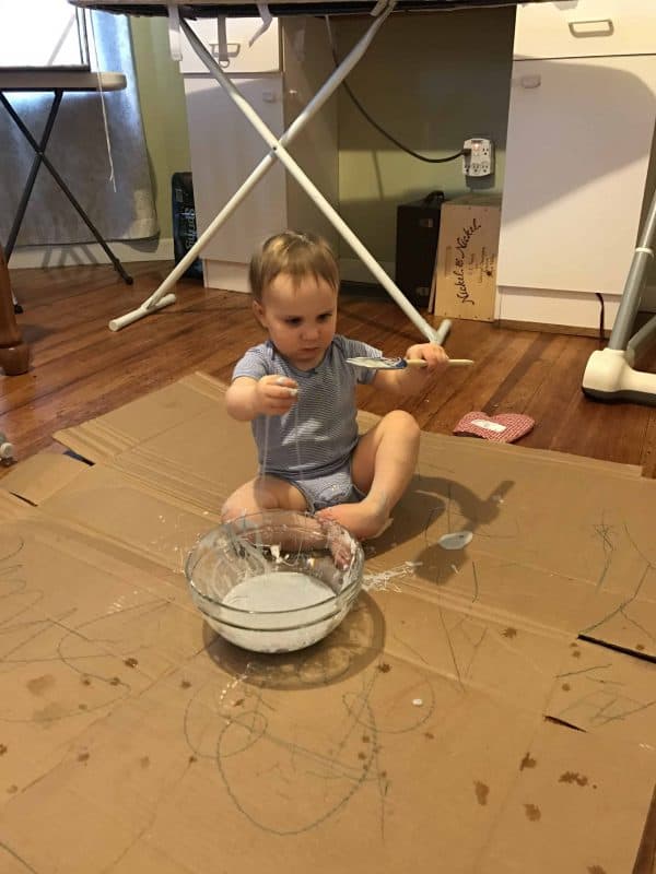 toddler playing with oobleck