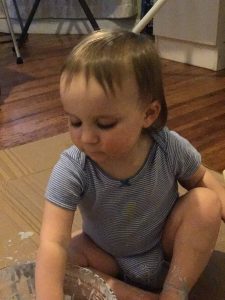 toddler playing with paint