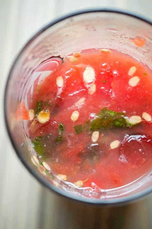 watermelon and basil muddled in a glass