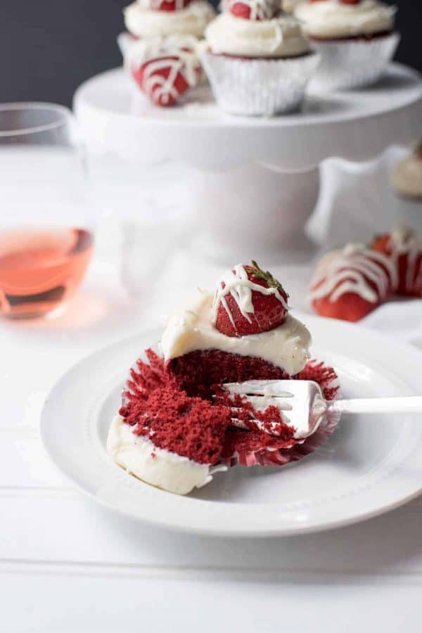 fork cutting into red velvet cupcakes