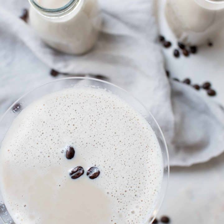 overhead shot of coffee milk martini with coffee beans