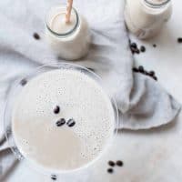 overhead shot of coffee milk martini with coffee beans