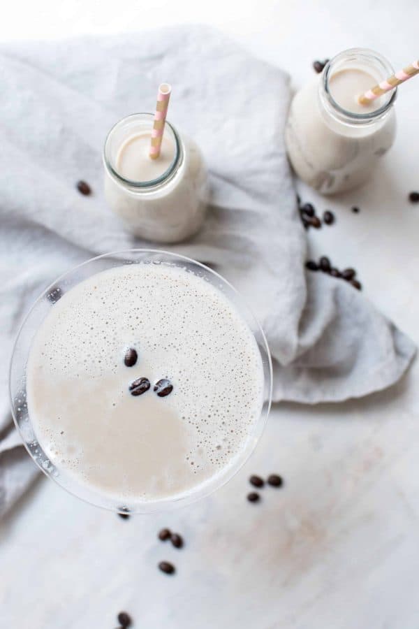 overhead shot of coffee milk martini with coffee beans