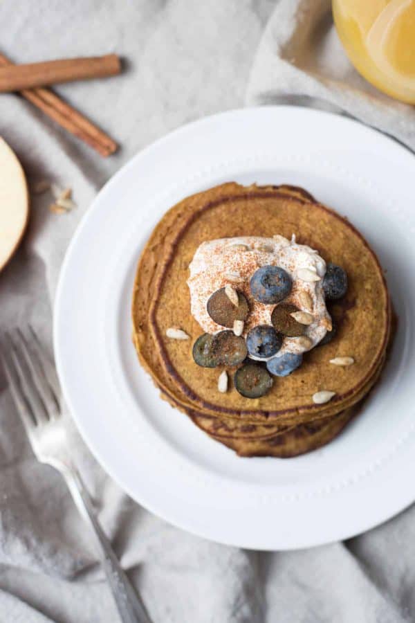 overhead view of pumpkin spice pancakes stacked on a plate