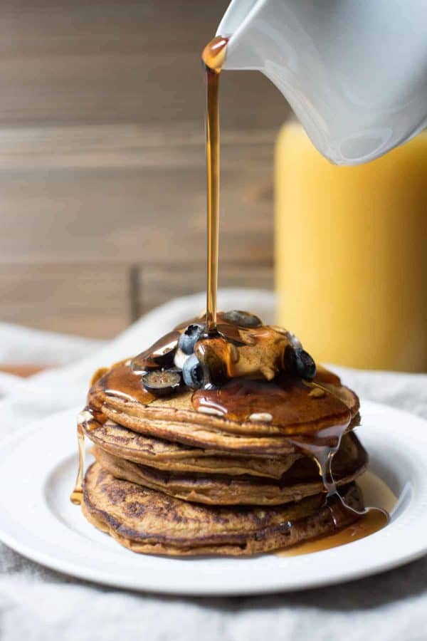 maple syrup pouring over Pumpkin Spice Blender Pancakes