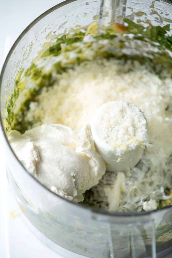 ingredients for lemon ricotta pesto in a food processor