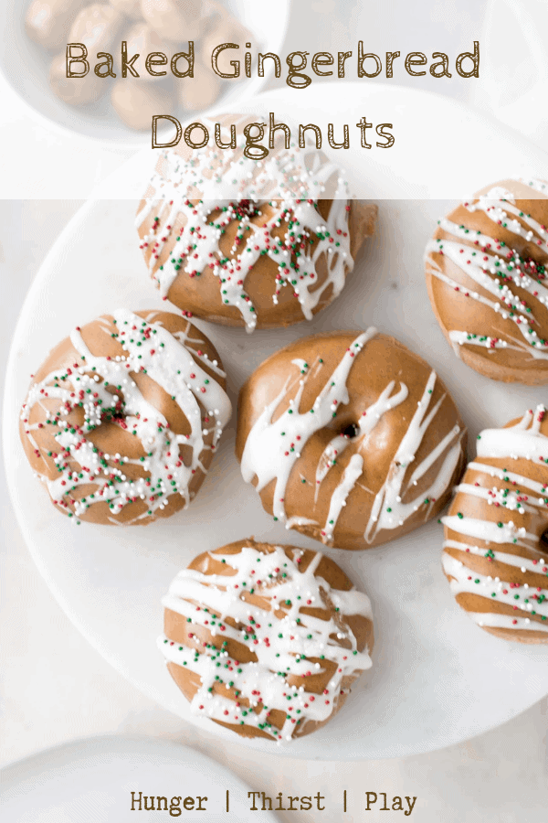 The perfect holiday breakfast or sweet treat. Everything you love about fluffy light doughnuts without the frying! Warming gingerbread spices are added to the dough with the perfect gingerbread icing on top. These gingerbread doughnuts are the best way to start your holiday baking! #holidaybaking #bakeddoughtnuts
