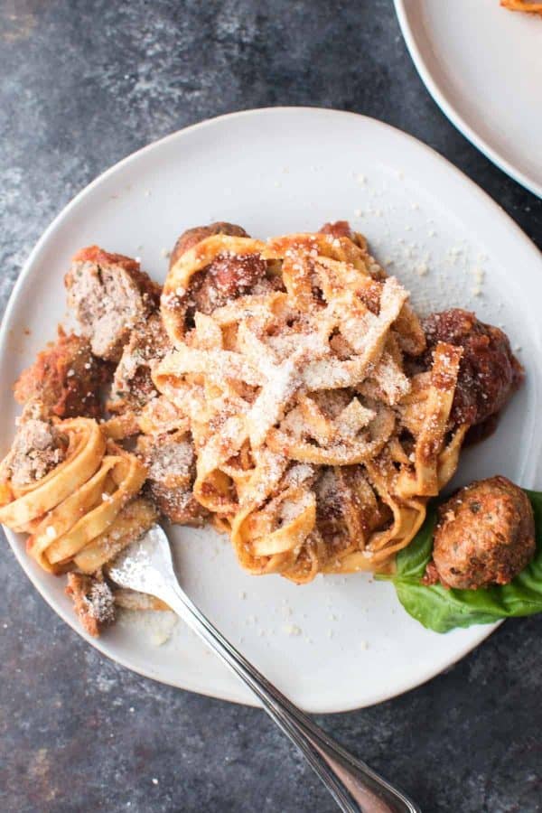 linguine wrapped around a fork with meatballs