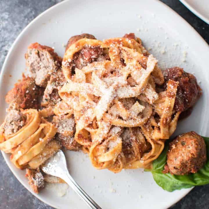 linguine wrapped around a fork with meatballs