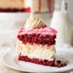 Creamy New York style cheesecake between layers of red velvet cake.