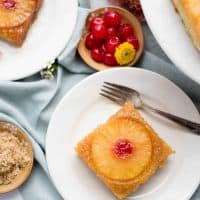 overhead view of a slice of pineapple upside down cake on a plate with a fork