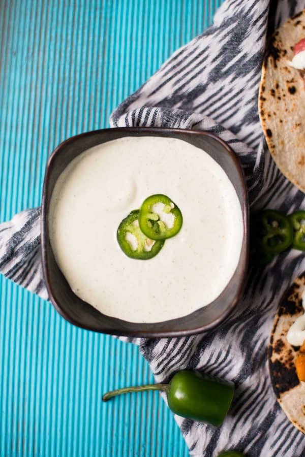 bowl of creamy jalapeño crema sauce for topping tacos