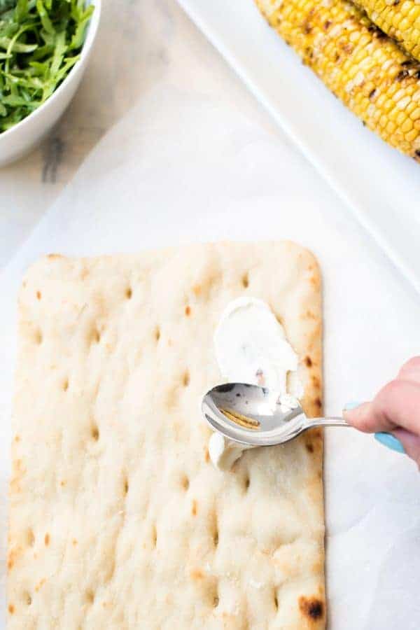 Simple Summer Flatbread with Grilled Corn, Arugula, Mascarpone + Goat Cheese. Just the right amount of crunch, creamy, sweet and savory - made in a flash!