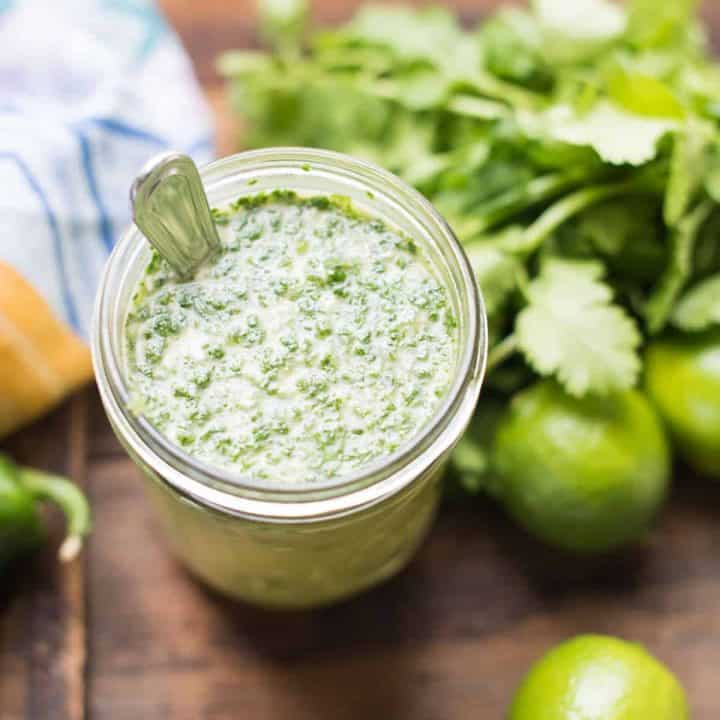 cilantro lime marinade in a mason jar surrounded by ingredients