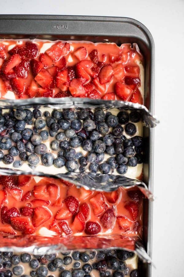 Red White and Blue Cheesecake Bars are a delicious Patriotic sweet treat with fresh summer fruit, creamy filling and crispy gluten free crust.