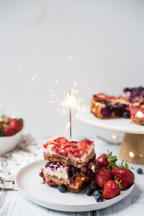 Red White and Blue Cheesecake Bars are a delicious Patriotic sweet treat with fresh summer fruit, creamy filling and crispy gluten free crust.