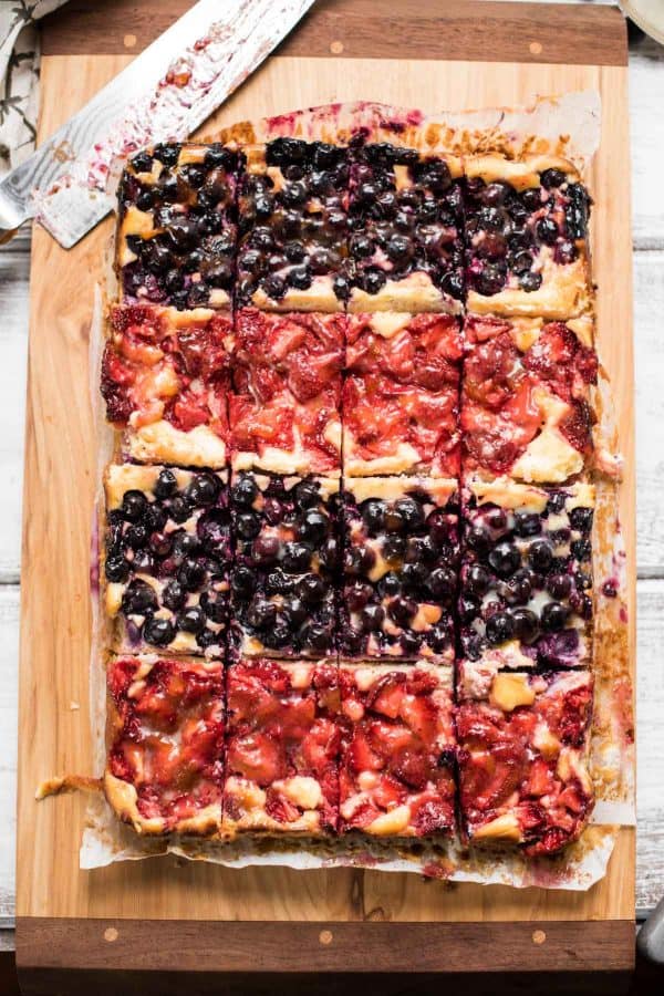 Red White and Blue Cheesecake Bars are a delicious Patriotic sweet treat with fresh summer fruit, creamy filling and crispy gluten free crust.