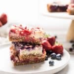 stacked squares of red white and bue cheesecake bars