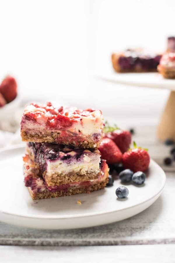 Red White and Blue Cheesecake Bars are a delicious Patriotic sweet treat with fresh summer fruit, creamy filling and crispy gluten free crust.