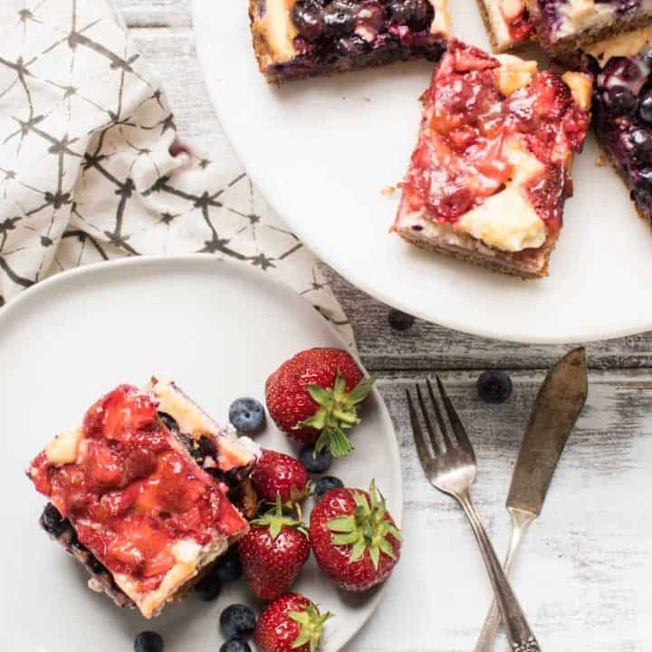 Red White and Blue Cheesecake Bars are a delicious Patriotic sweet treat with fresh summer fruit, creamy filling and crunchy gluten free crust.