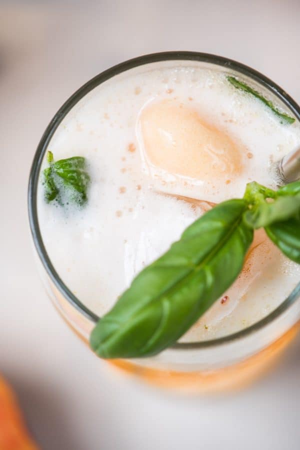 Summery Peach Basil Gin Floats are the perfect cold summer cocktail to cool off in the heat.