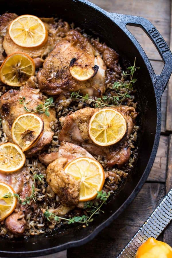 Lemon chicken thighs over wild rice in lodge cast iron pan