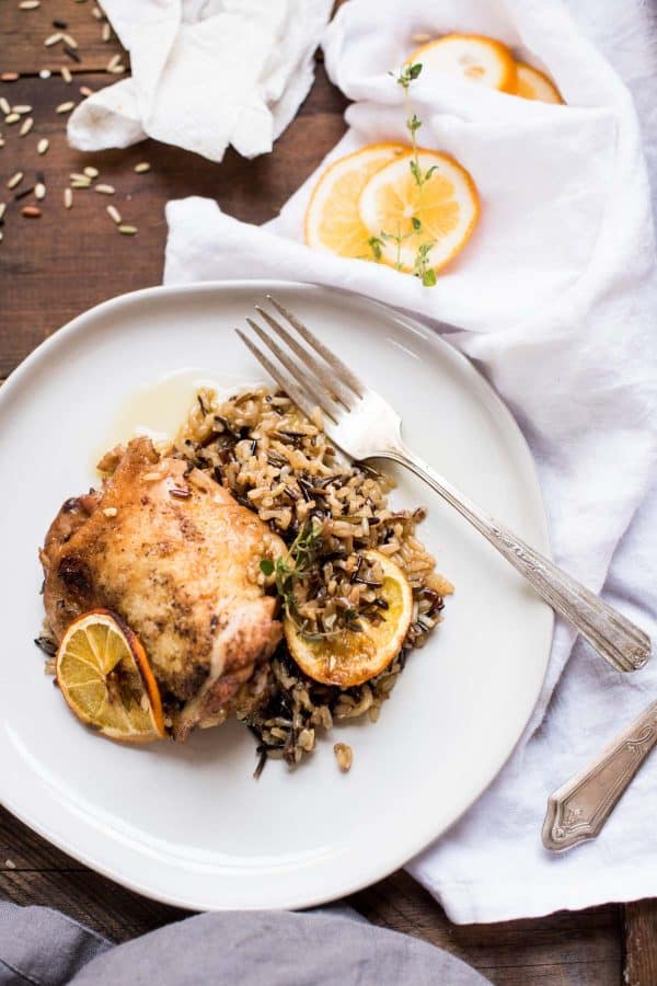 Meyer lemon chicken thighs and wild rice on a plate.