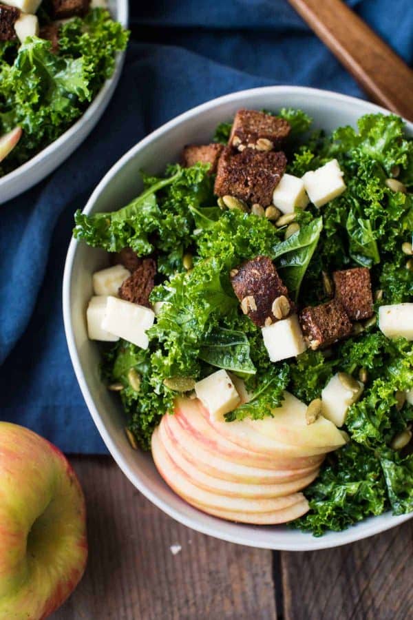 Overhead shot of autumn kale salad served in bowls