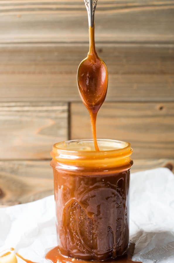 Salted caramel sauce dripping off spoon