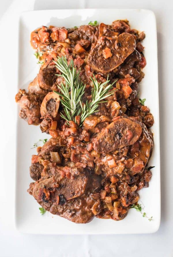 Overhead photo of veal osso bucco on a platter