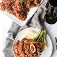 Overhead of plated osso bucco and plater of osso bucco