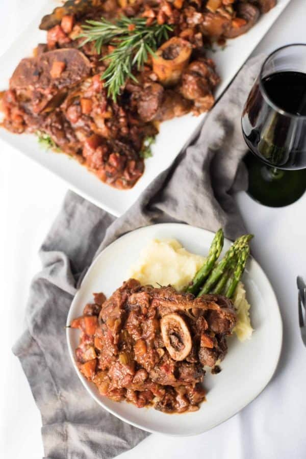 Overhead of plated osso bucco and plater of osso bucco