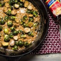 overhead view of marsala braised brussel sprouts in cast iron pan