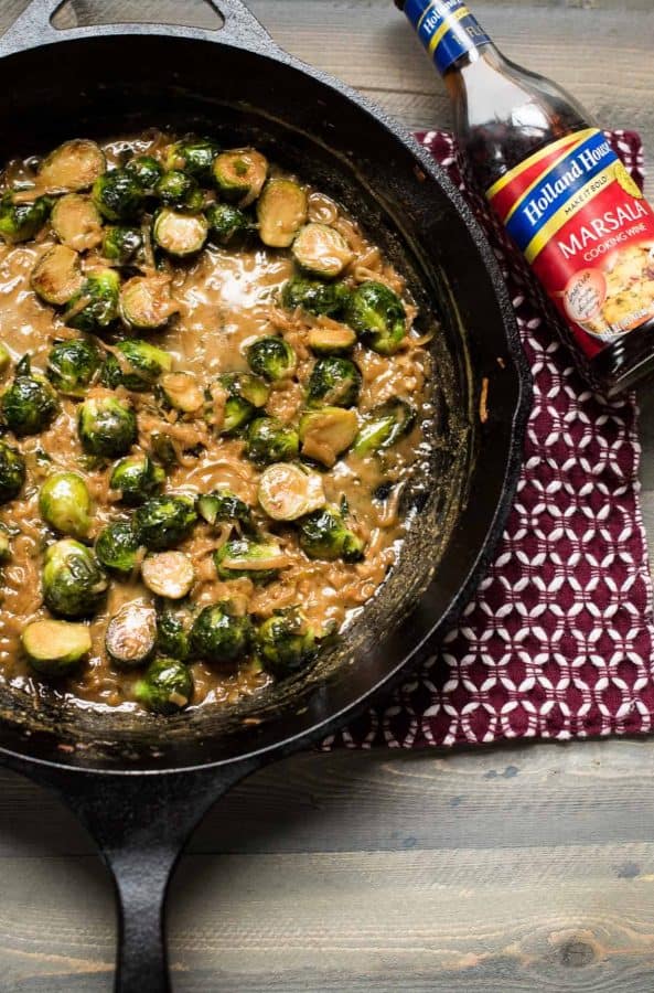 overhead view of marsala braised brussel sprouts in cast iron pan