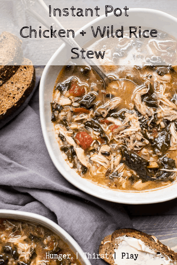 Tender pulled chicken, wild rice, tuscan kale and chopped tomatoes in rich chicken stock cooks up in no time in the Instant Pot. #instantpotsoup #chickenandrice #heartystews