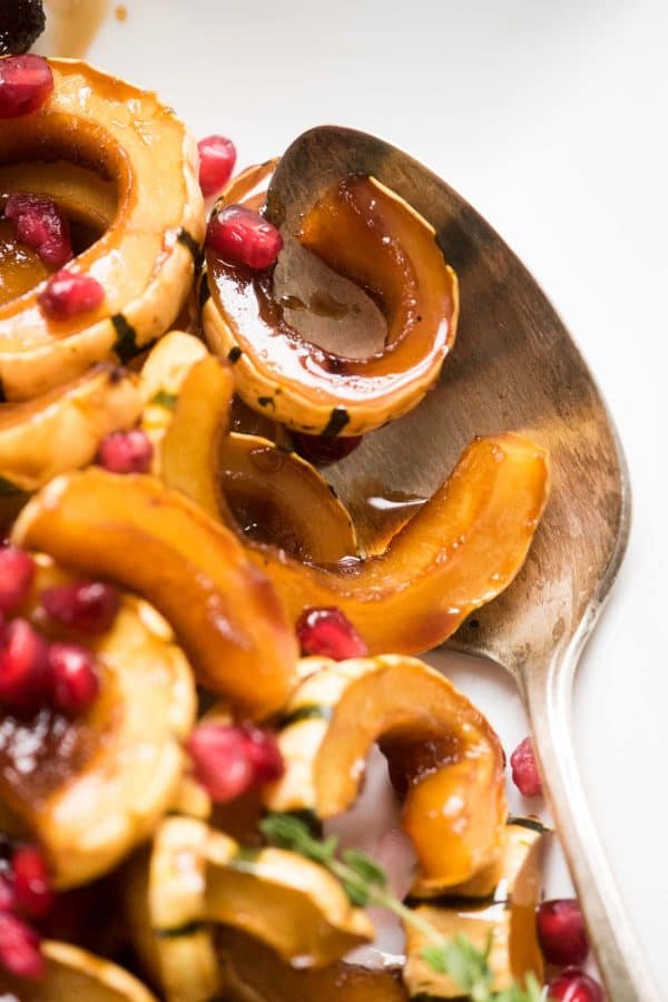 Close up of maple soy roasted squash with pomegranate