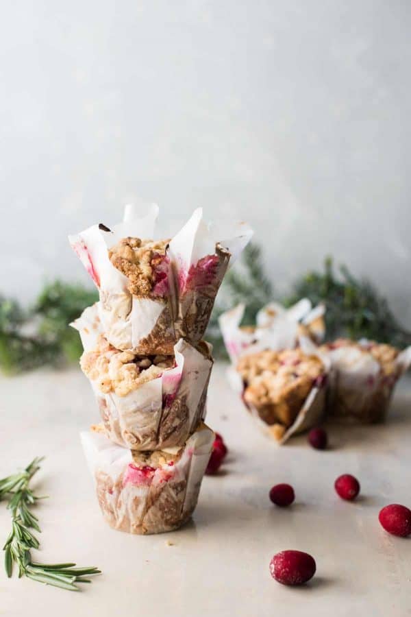 stacked cranberry rosemary muffins with white chocolate crumble