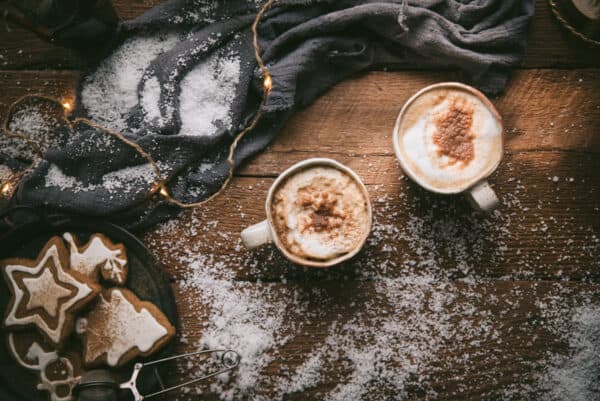 overhead image of gingerbread lattes in white mugs