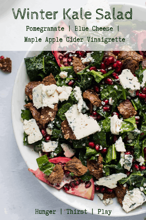 Crisp tuscan kale, creamy salty blue cheese, sweet pomegranate and crunchy brown bread croutons tossed with maple apple cider vinaigrette. Perfect kale salad for entertaining or bringing to a gathering. #wintersalads #saladsforacrowd