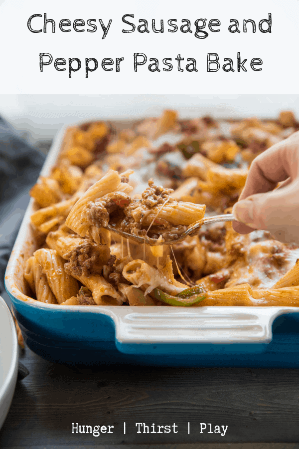 Comfort food pasta recipe to the weeknight dinner rescue! Classic sausage and peppers simmered in tomato sauce and baked with lots of mozzarella and rigatoni. This cheesy pasta recipe is a crow pleasing dish that is a simple, quick dinner. #pastabake #cheesypasta #sausageandpeppers via @hungrthirstplay