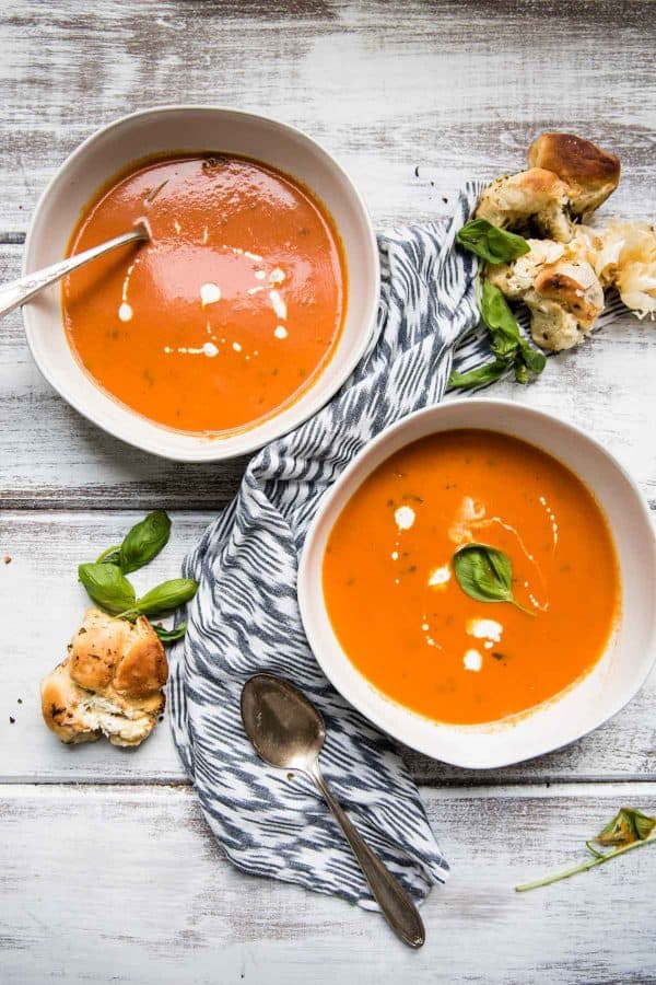 Overheat view of two bowls of creamy tomato soup