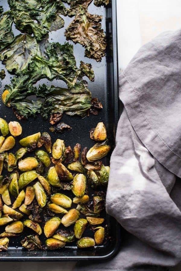 roasted brussels sprouts and crispy kale in a sheet pan