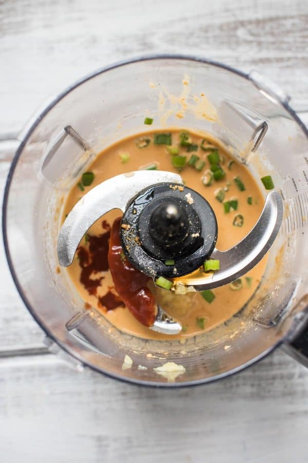 overhead photo of thai peanut dressing ingredients in the food processor