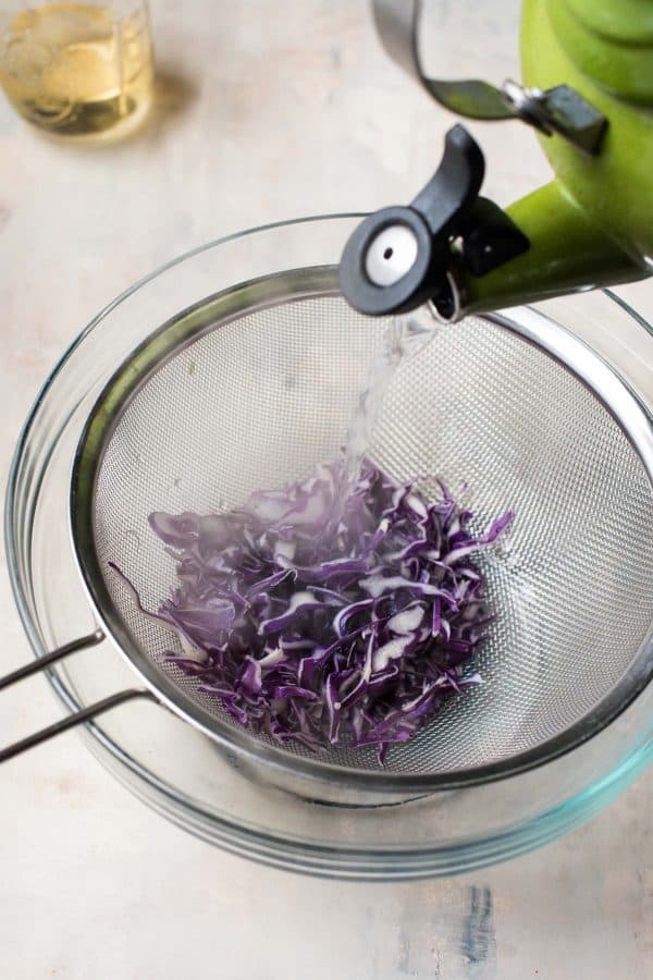 steeping the sliced red cabbage to be pickled