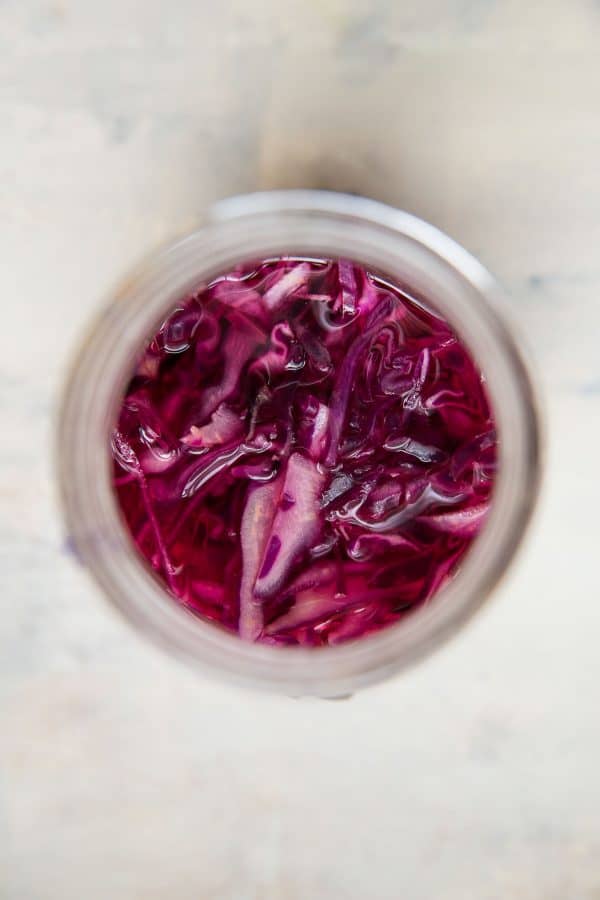 Overhead view of quick pickled cabbage in a mason jar