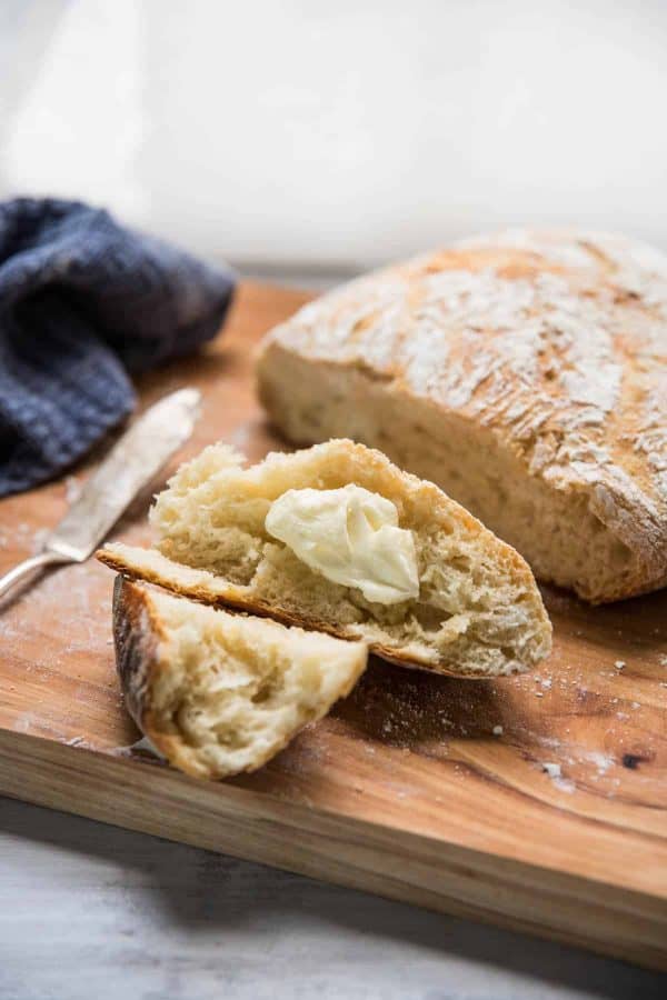 buttered pieces of fresh crusty no-knead bread