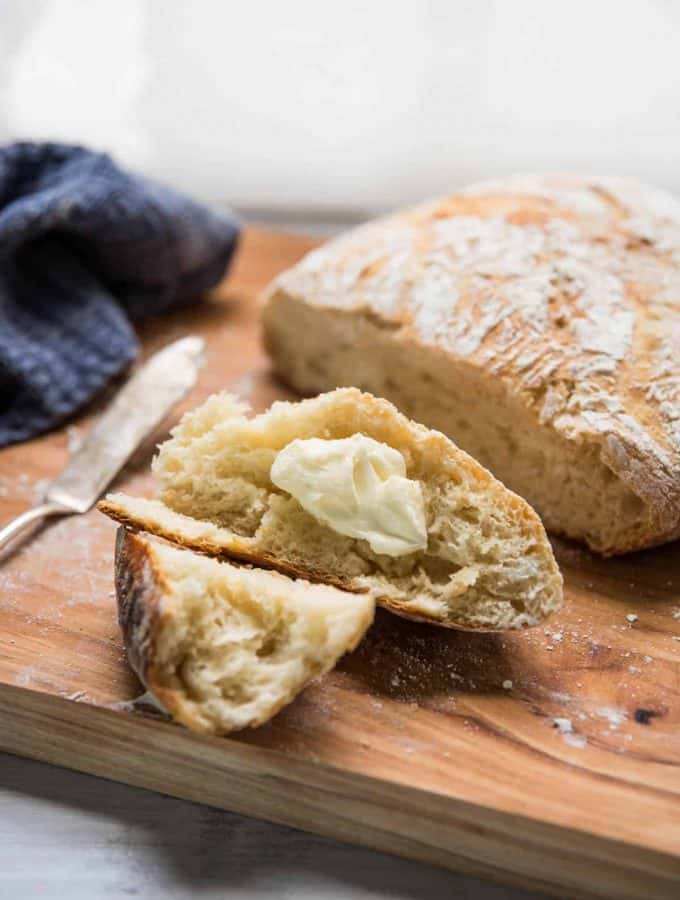 buttered pieces of fresh crusty no-knead bread