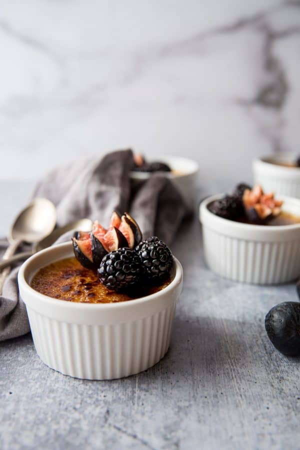 creme brulee with grand mariner garnished with figs and blackberries